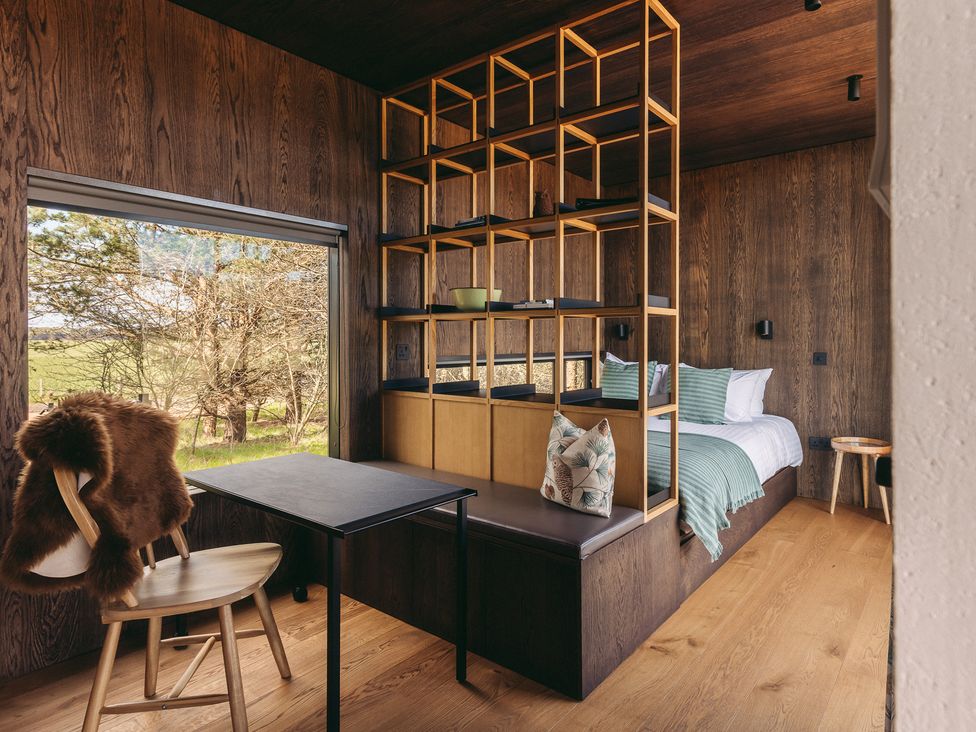 A bedroom with a bed and a desk at Goose in St. Andrews