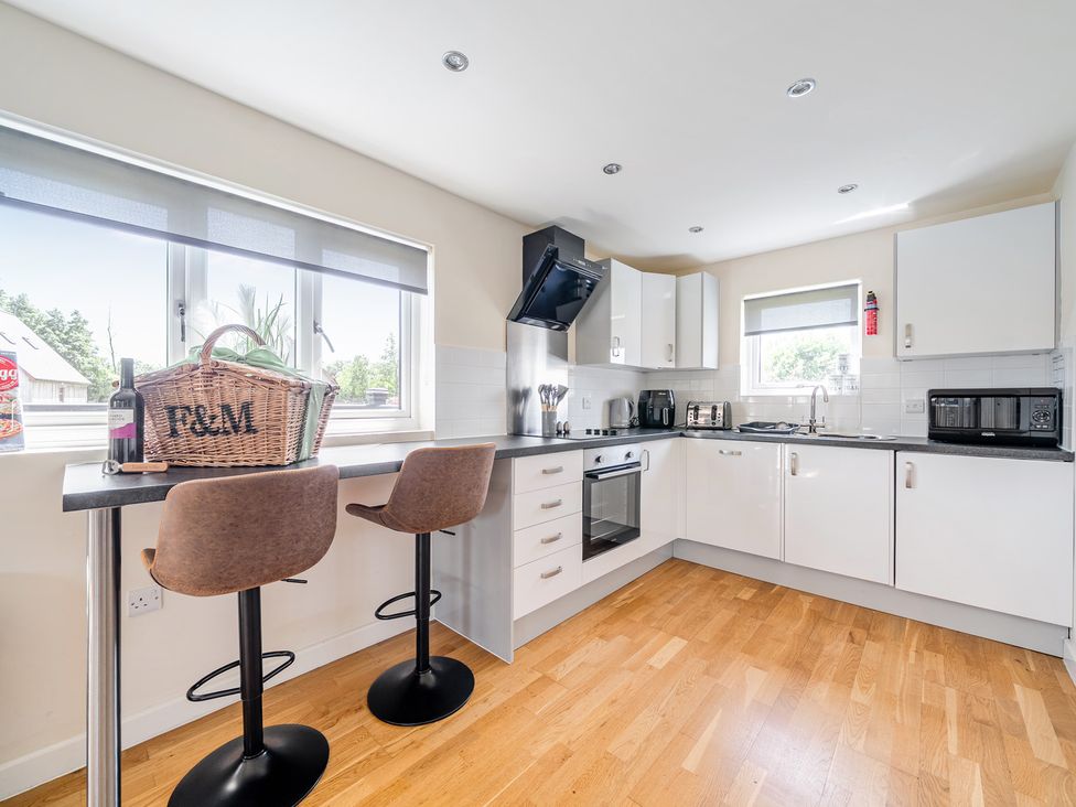 A kitchen with appliances and seating at James Ville Marina Lodge 7 in Brigg