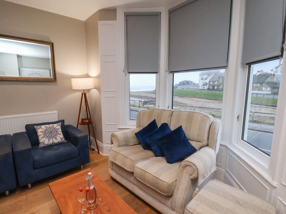 A living room with a sofa and armchair at South Villa Sandsend near Whitby