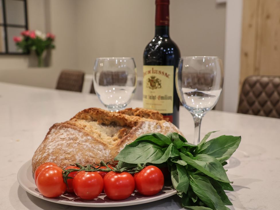 A kitchen with a bottle of wine and food items at South Villa Sandsend near Whitby
