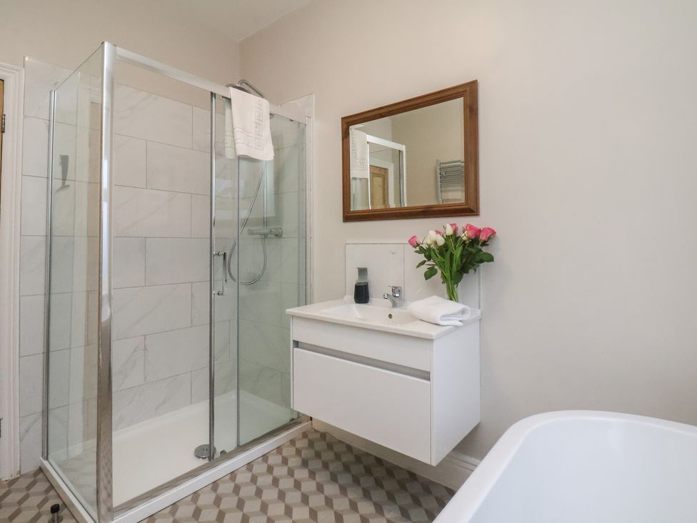 A bathroom with a shower and sink at South Villa Sandsend near Whitby