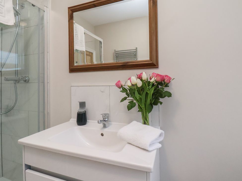 A bathroom with sink and mirror at South Villa Sandsend near Whitby