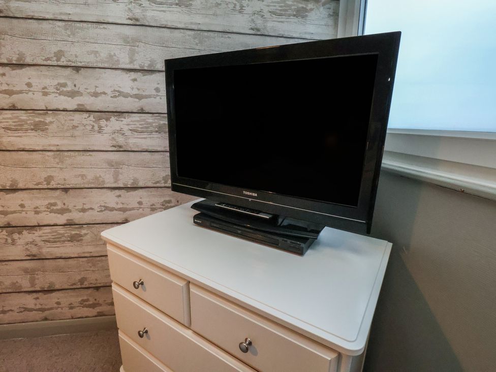 A television and DVD player on a chest of drawers at South Villa in Sandsend near Whitby