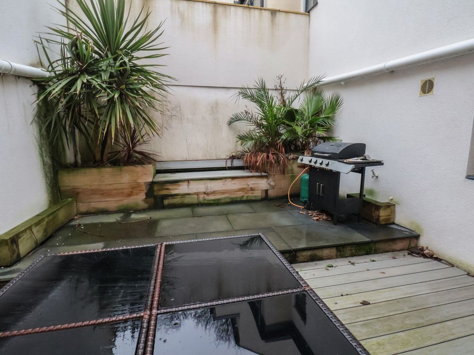 An outdoor area with a grill and planters at South Villa Sandsend near Whitby