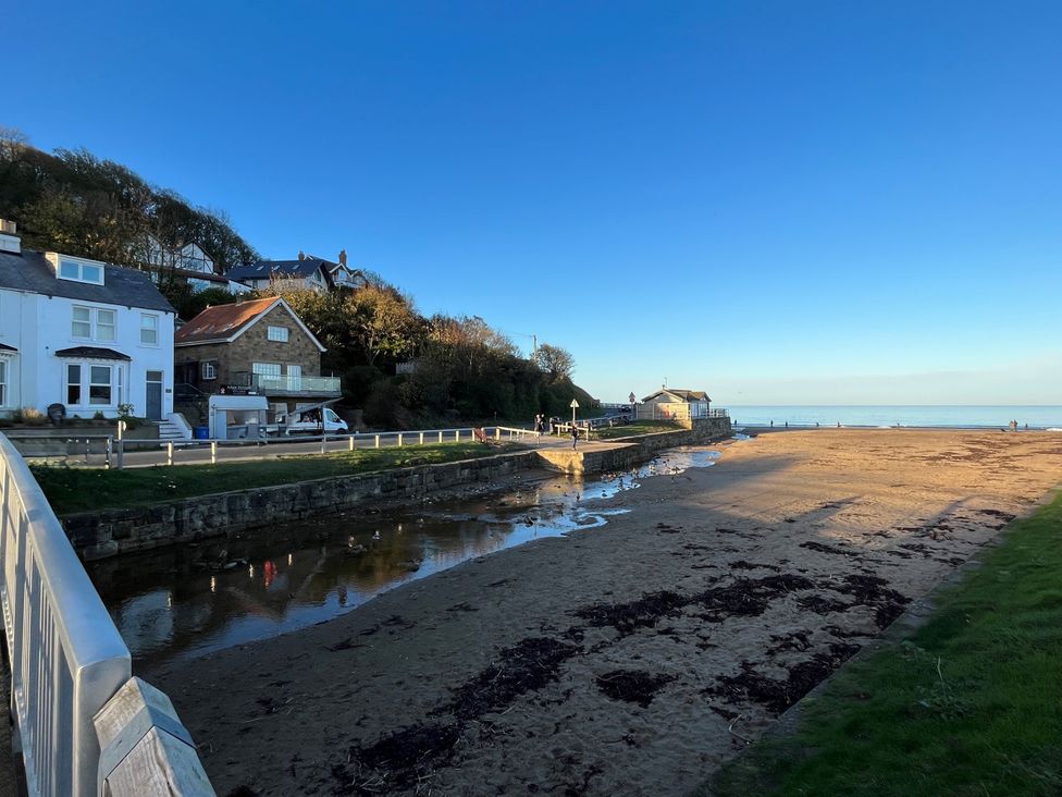 A beach view with houses and water at South Villa Sandsend near Whitby