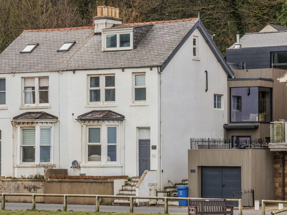 A house with a staircase and fence at South Villa Sandsend near Whitby