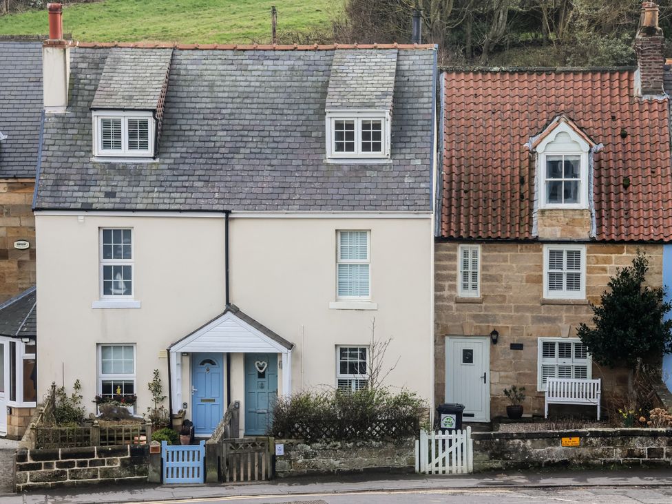 A house with a blue door and garden at South Villa in Sandsend near Whitby