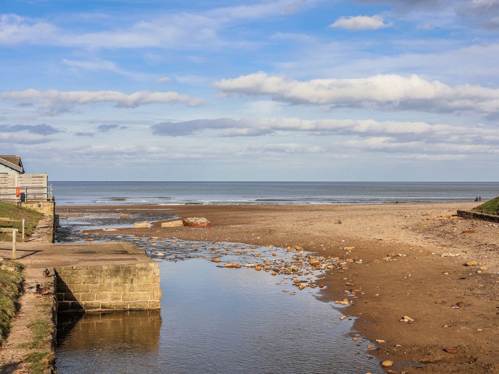 A beach scene with water and sand at South Villa in Sandsend near Whitby