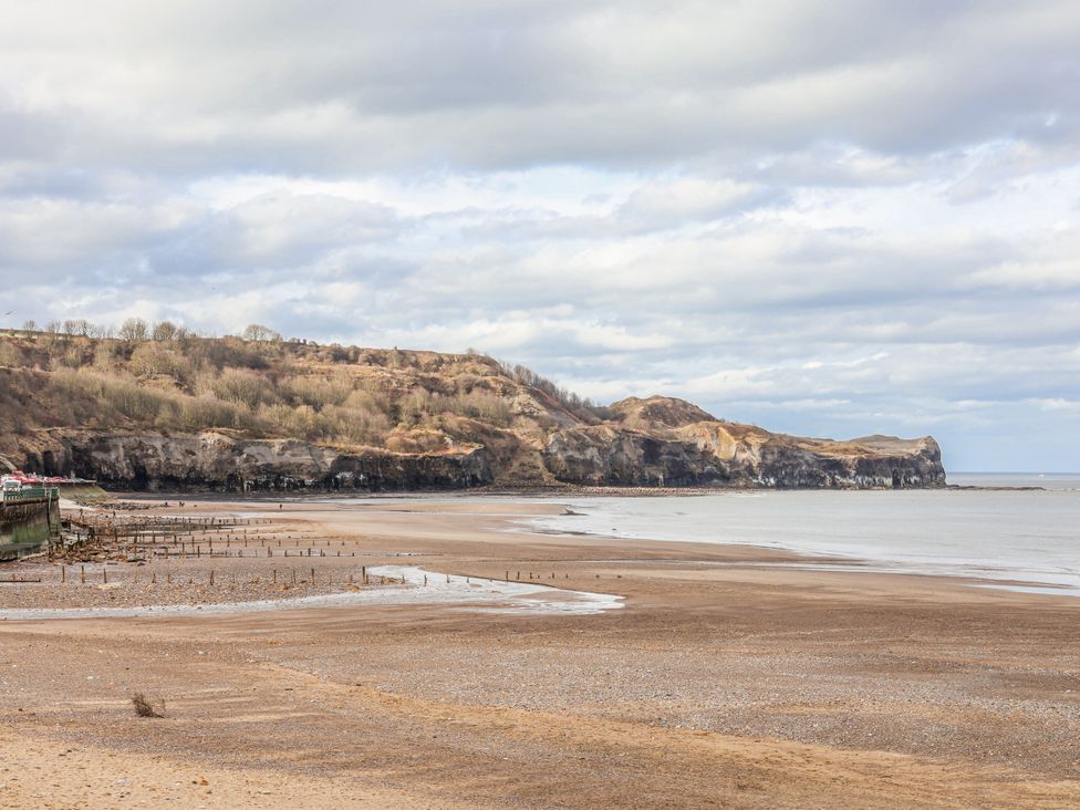 A beach with cliffs and sea at South Villa in Sandsend near Whitby