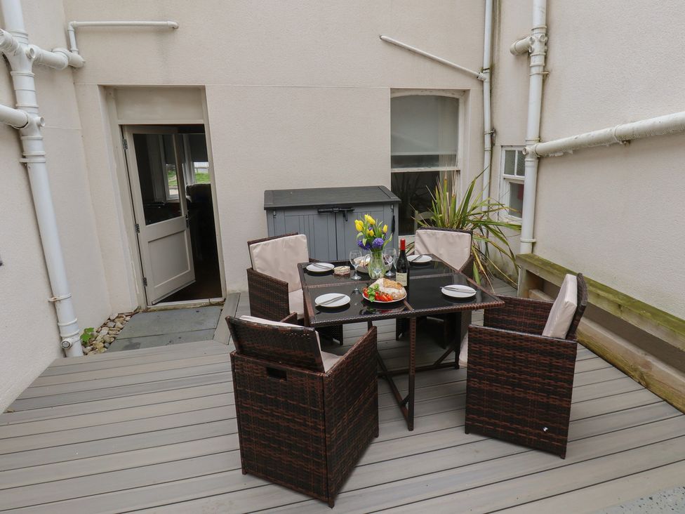 An outdoor dining area with a table and chairs at South Villa in Sandsend near Whitby