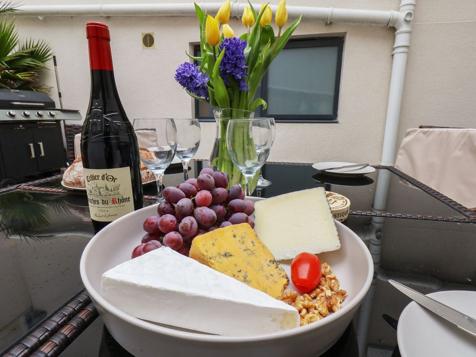 A cheese platter with grapes and wine at South Villa in Sandsend near Whitby