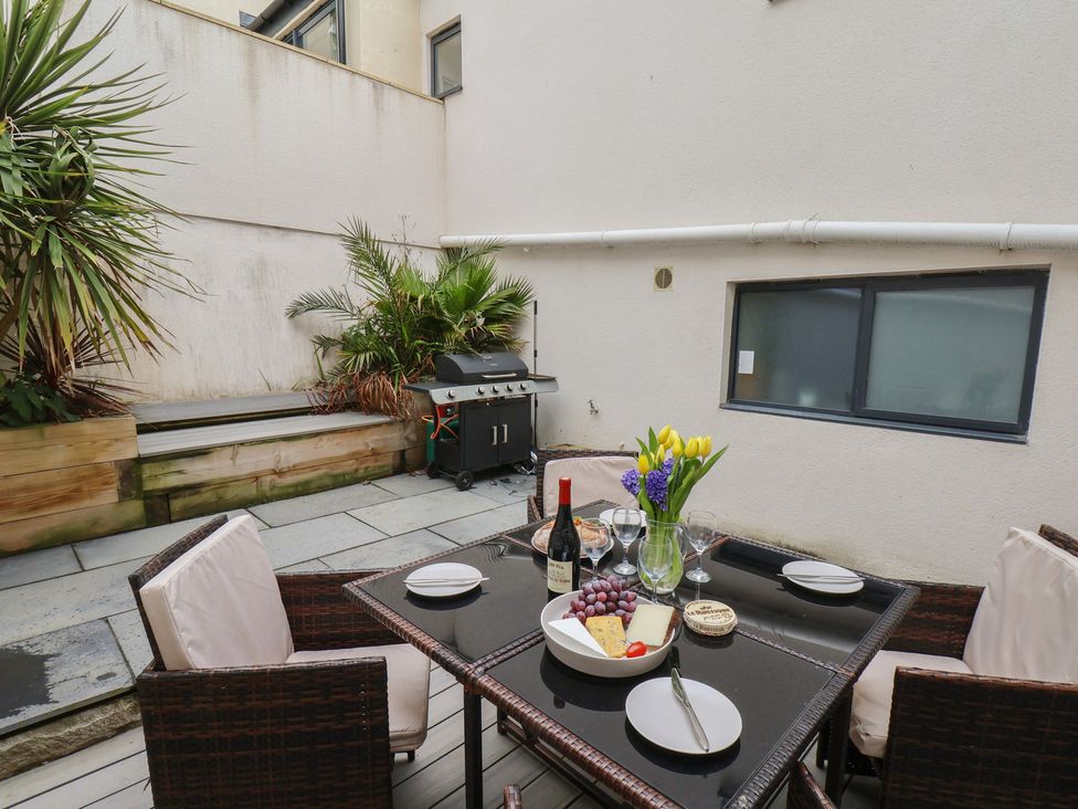 An outdoor patio area with a table and chairs at South Villa in Sandsend near Whitby