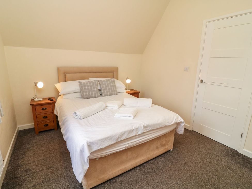 A bedroom with a bed and bedside table at James Ville Marina Lodge 9 in Brigg