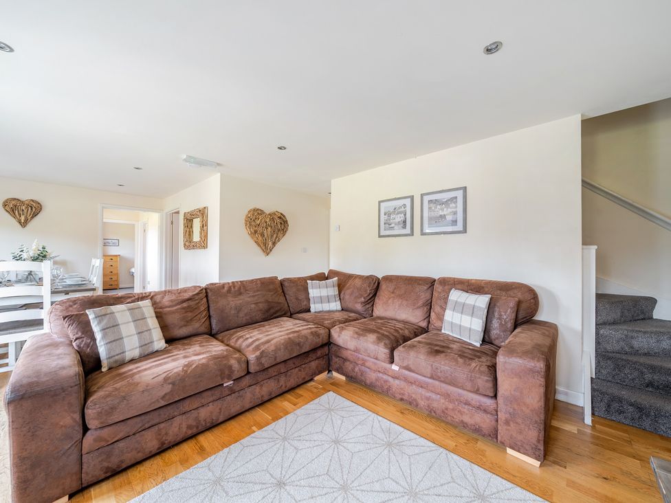 A living room with a sofa and dining area at James Ville Marina Lodge 9 in Brigg