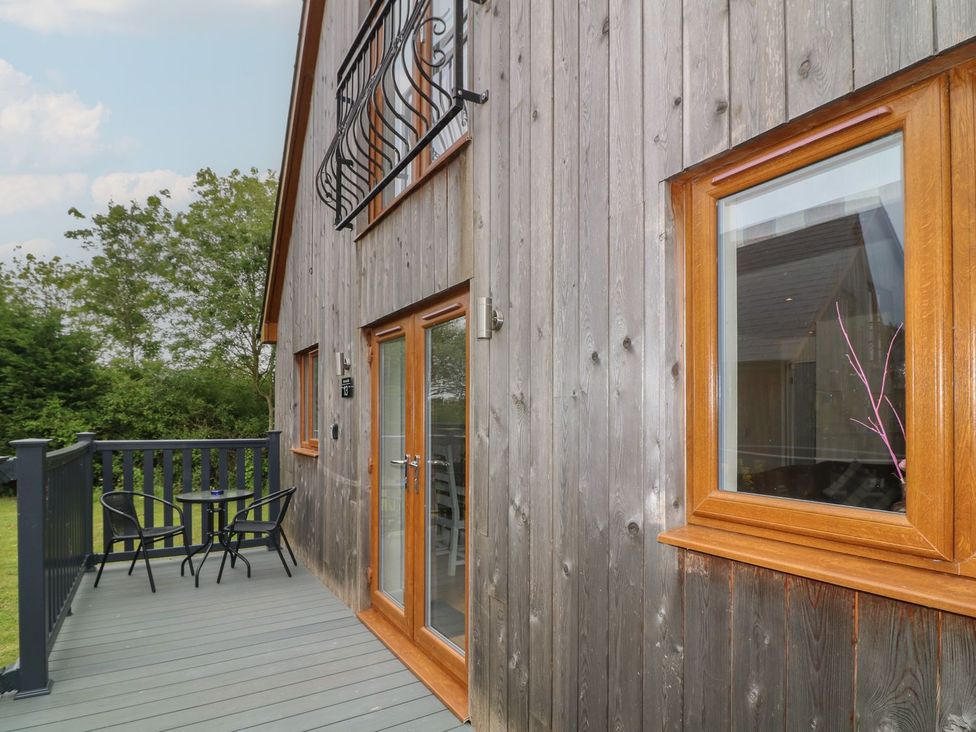 A deck with chairs and a table at James Ville Marina Lodge 13 in Brigg