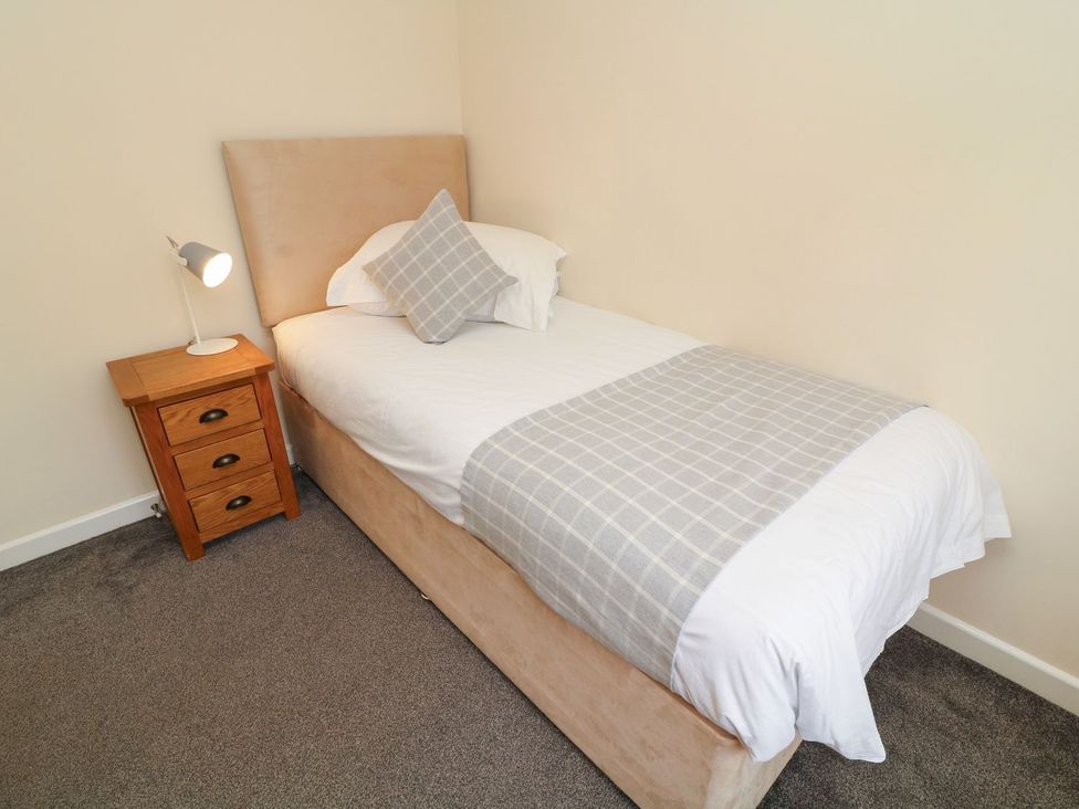 A bedroom with a single bed and a nightstand at James Ville Marina Lodge 14 in Brigg