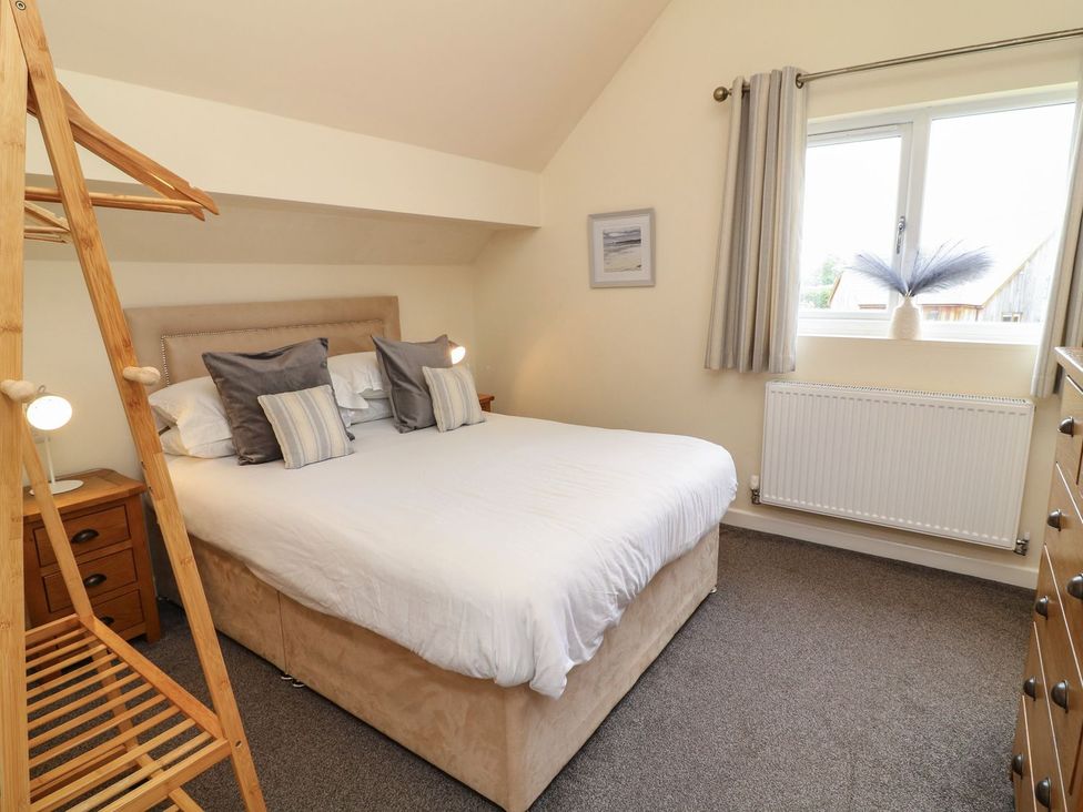A bedroom with a double bed and bedside table at James Ville Marina Lodge 14 in Brigg