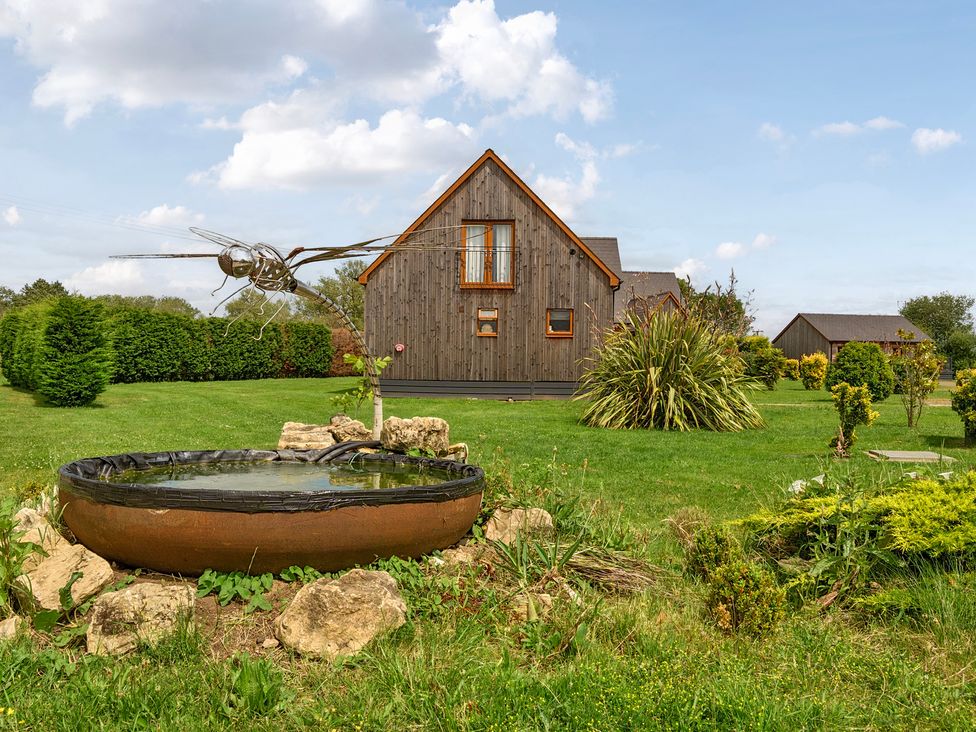 A house and garden with a water feature at James Ville Marina Lodge 14 Brigg