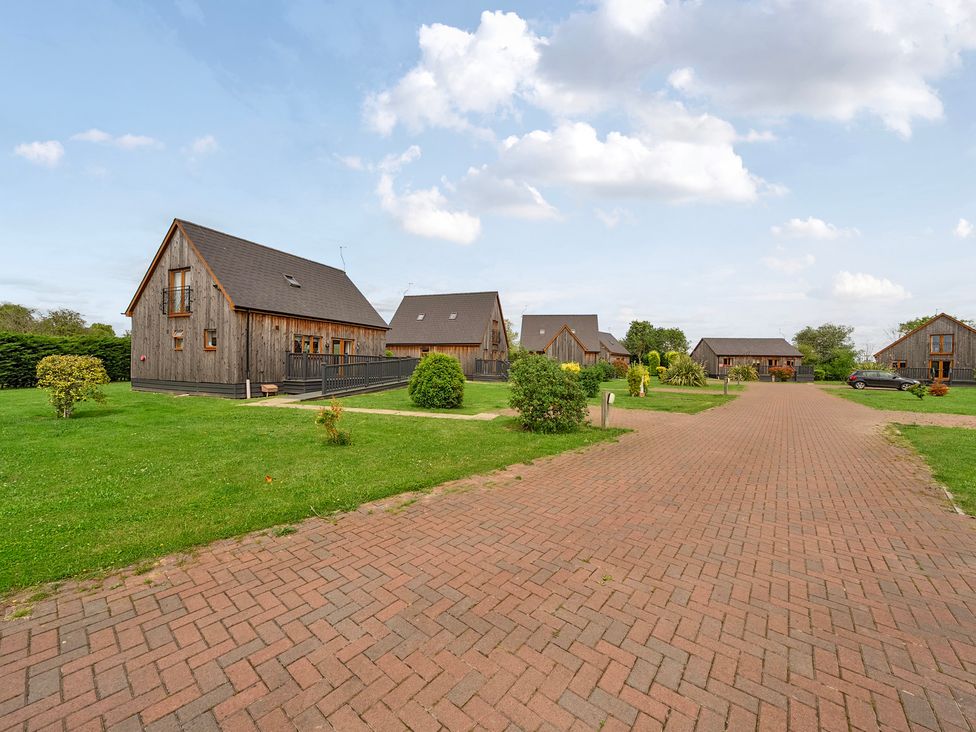 An area with multiple wooden houses and a pathway at James Ville Marina Lodge 14 in Brigg