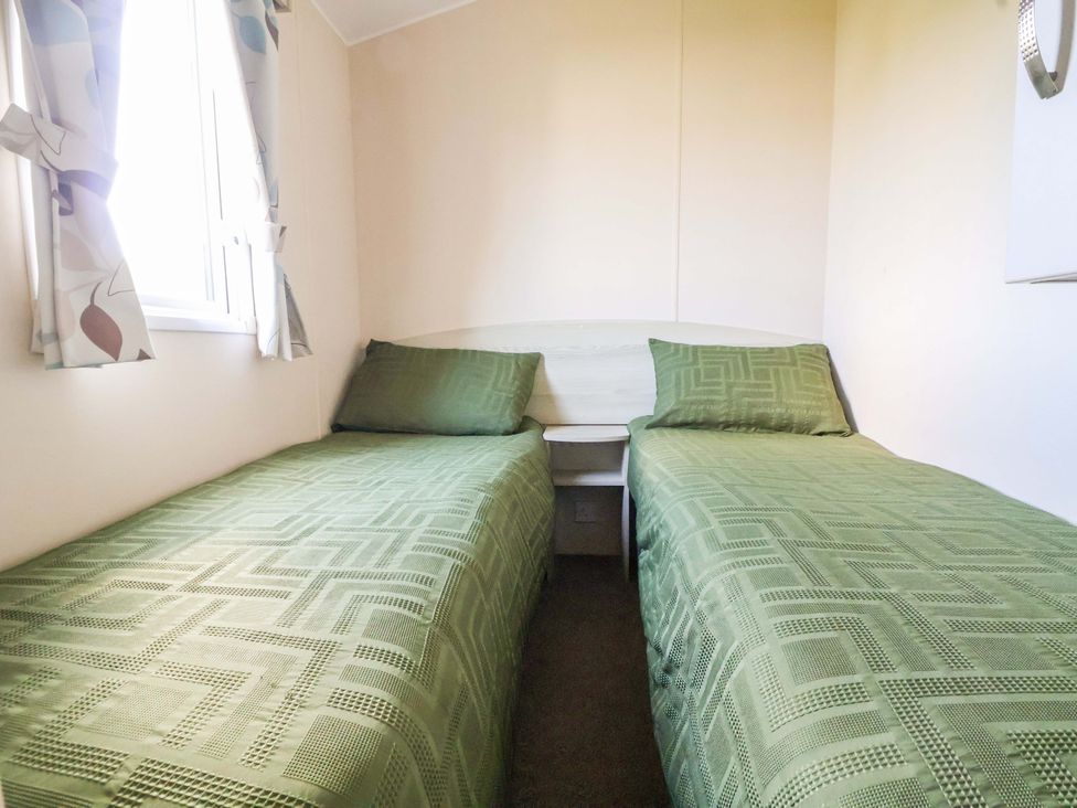 A bedroom with two single beds at Dunes View in Prestatyn