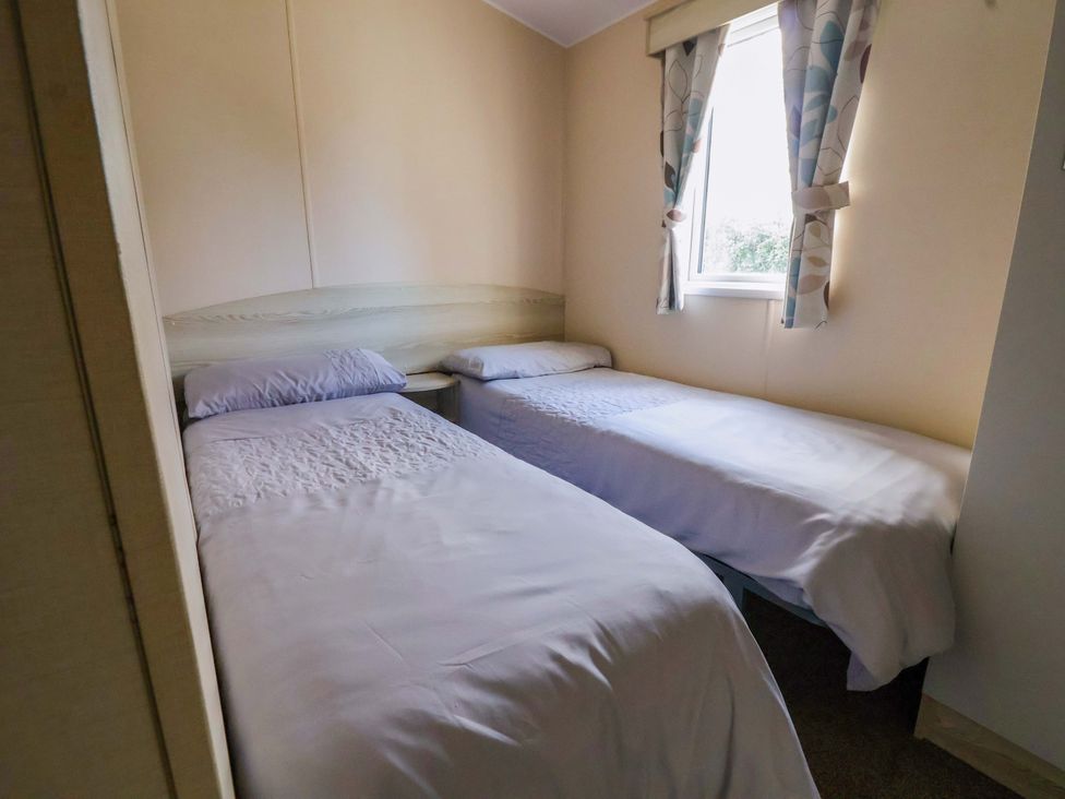 A bedroom with two beds and a window at Dunes View in Prestatyn