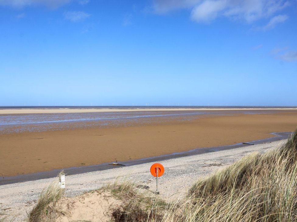 A beach with sand and water at Dunes View in Prestatyn