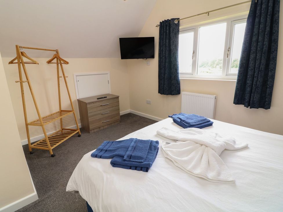 A bedroom with a bed and towels on it at James Ville Marina Lodge 21 Brigg