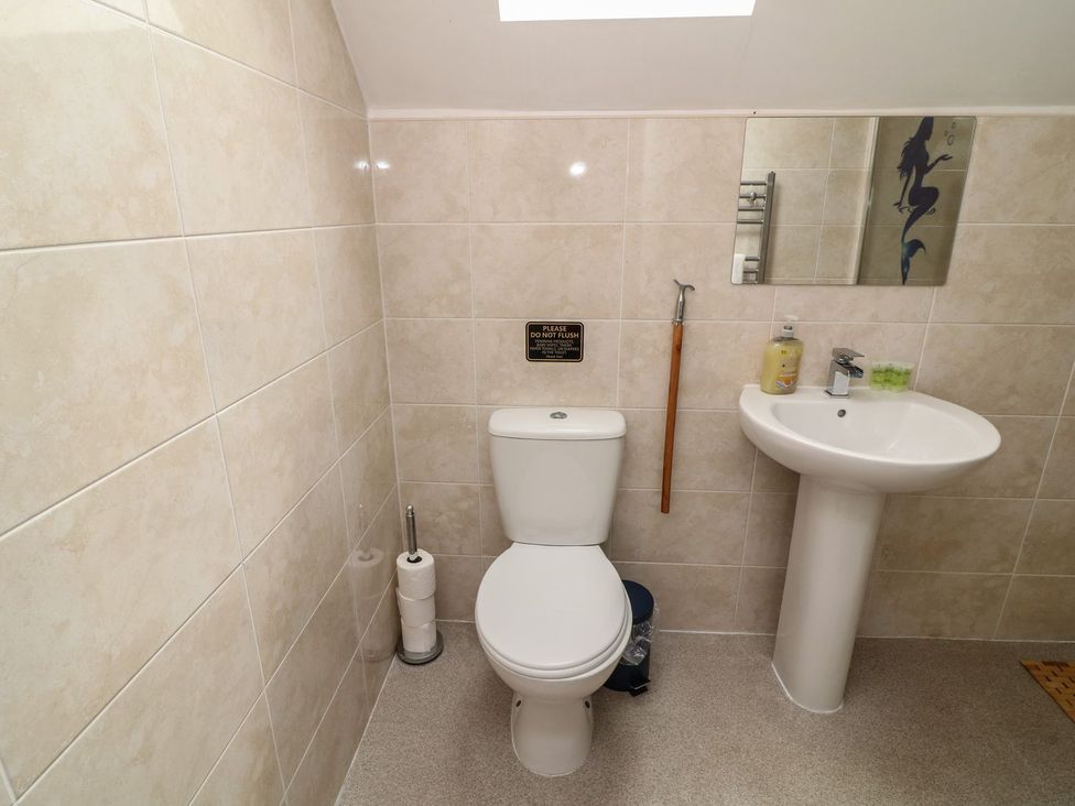 A bathroom with a toilet and a sink at James Ville Marina Lodge 21 in Brigg
