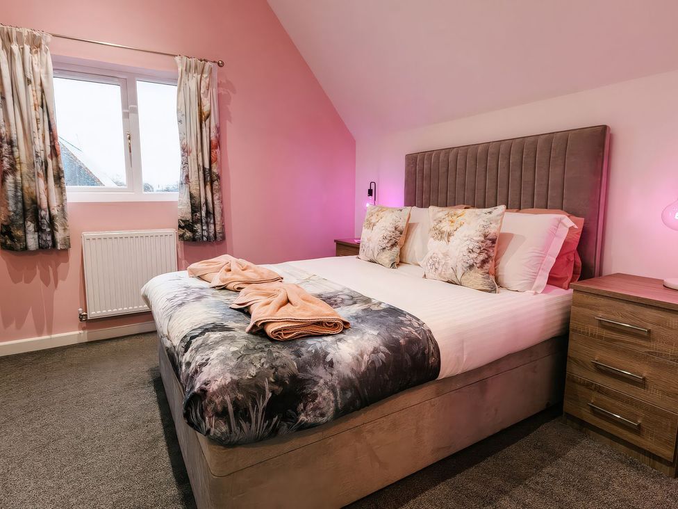 A bedroom with a bed and bedside table at James Ville Marina Lodge 23 in Brigg