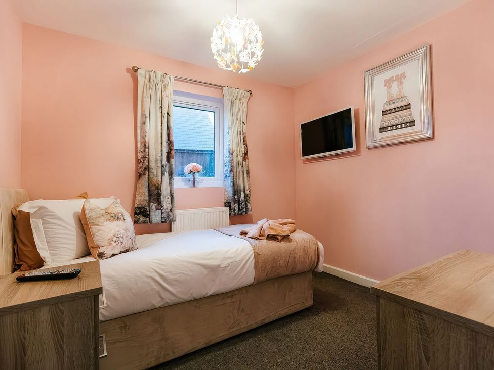 A bedroom with a bed and television at James Ville Marina Lodge 23 in Brigg