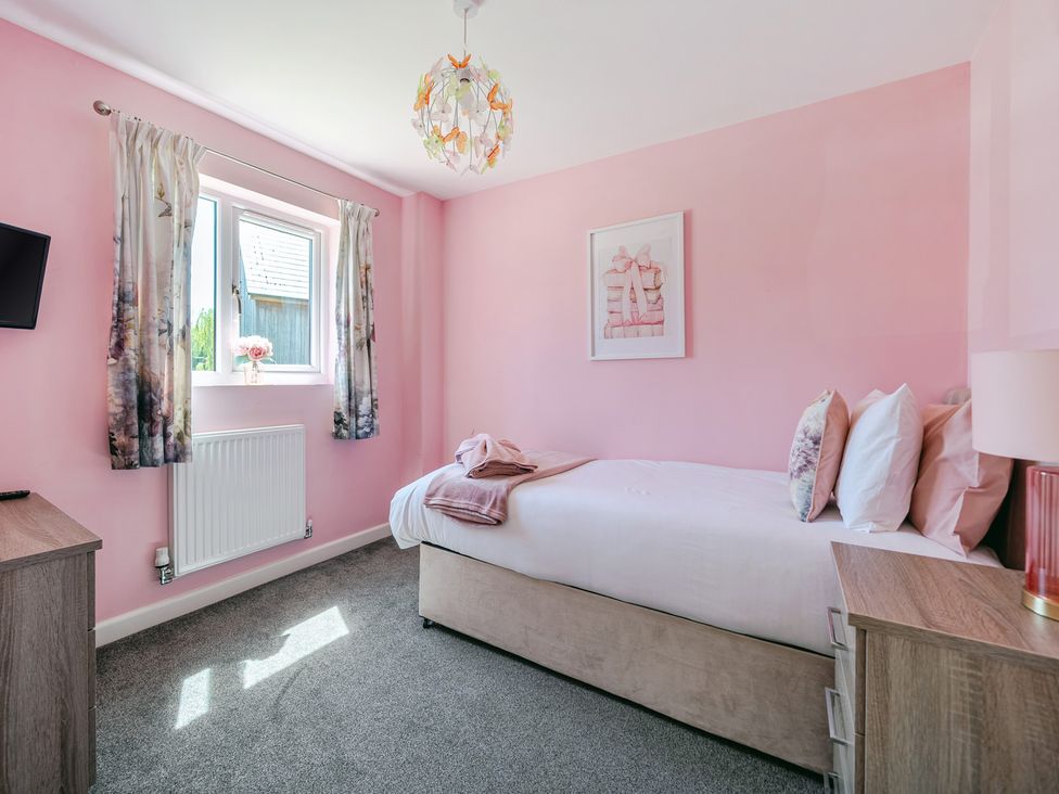 A bedroom with a bed and television at James Ville Marina Lodge 23 in Brigg