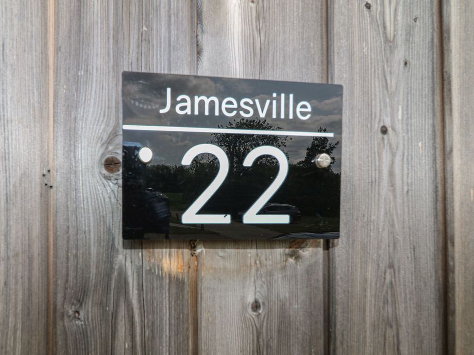 A plaque with the name Jamesville and the number 22 at James Ville Marina Lodge 22 Brigg
