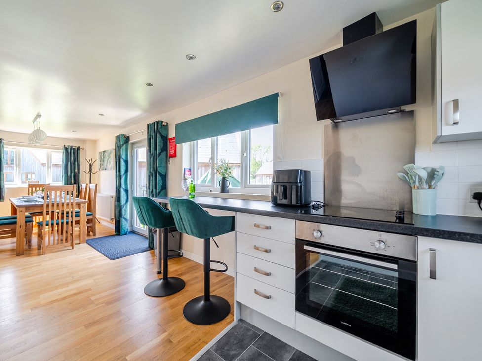 A kitchen with dining table and bar stools at James Ville Marina Lodge 22 Brigg