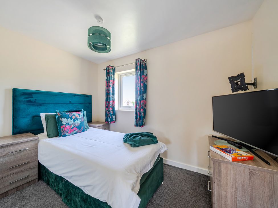 A bedroom with a bed and television at James Ville Marina Lodge 22 in Brigg