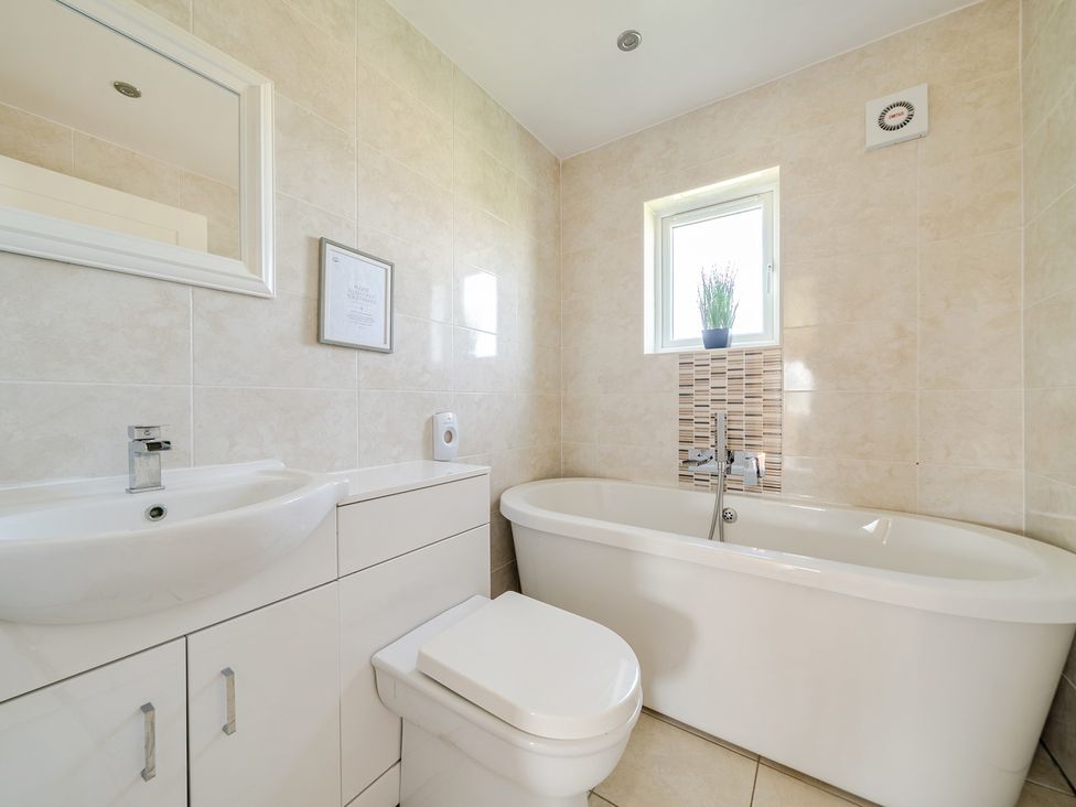 A bathroom with a bath tub and sink at James Ville Marina Lodge 22 in Brigg