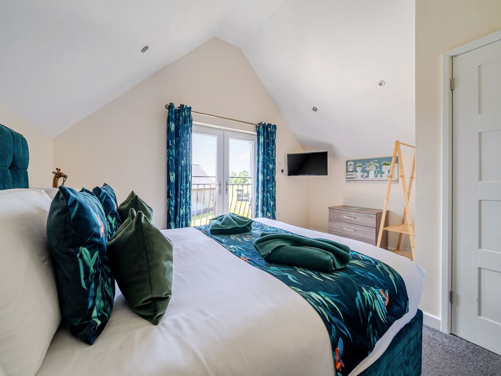 A bedroom with a bed and television at James Ville Marina Lodge 22 in Brigg