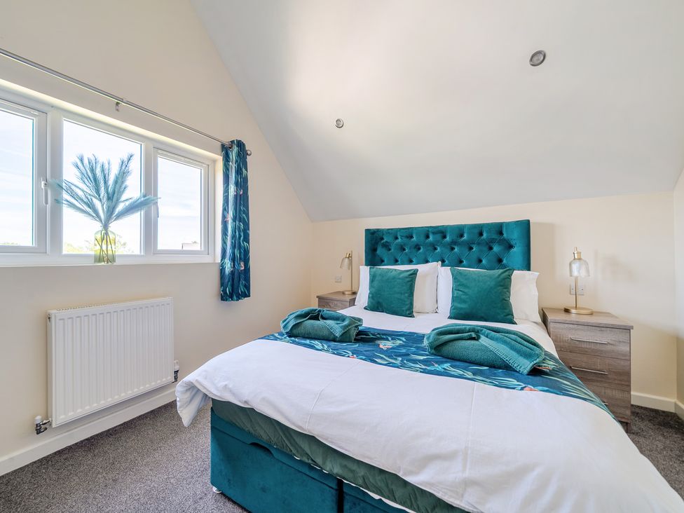 A bedroom with a bed and bedside table at James Ville Marina Lodge 22 in Brigg