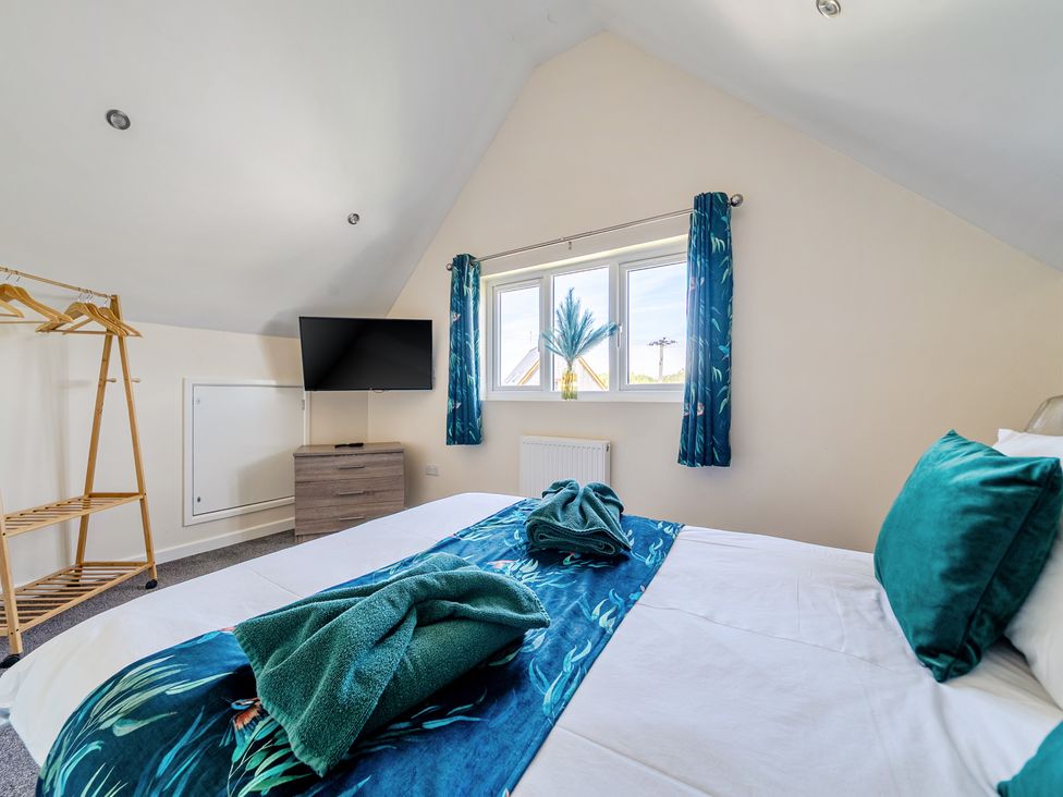 A bedroom with a bed and television at James Ville Marina Lodge 22 in Brigg
