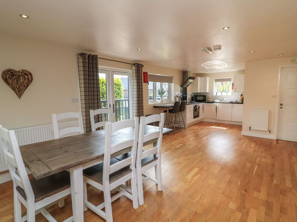 A kitchen with a dining table and chairs at James Ville Marina Lodge 10 in Brigg