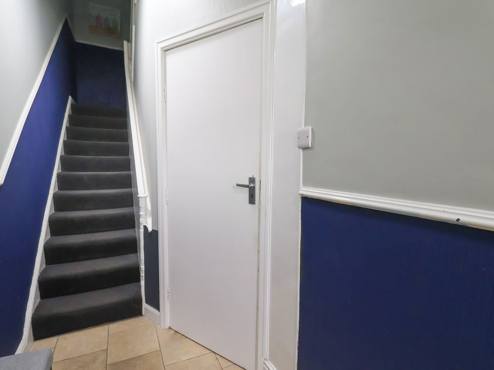 A hallway with stairs and a door at Apartment 1 Gr floor in Scarborough