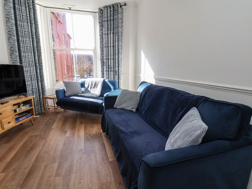 A living room with a sofa and television at Apartment 2 in Scarborough