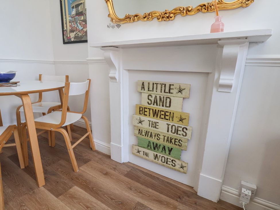 A dining room with a table and chairs at Apartment 2 in Scarborough