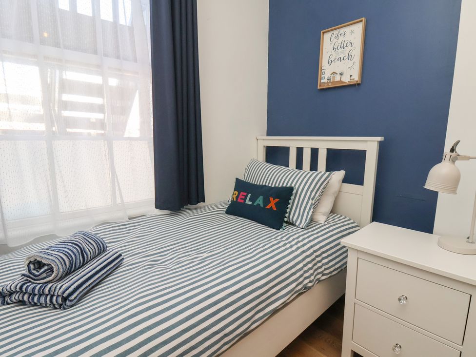 A bedroom with a bed and bedside table at Apartment 2 in Scarborough