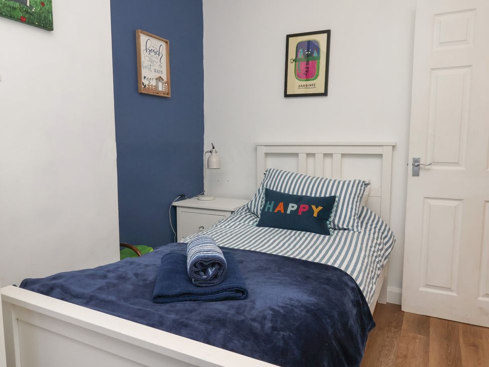 A bedroom with a bed and nightstand at Apartment 2 in Scarborough