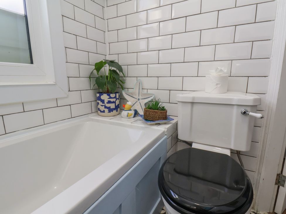 A bathroom with a bathtub and toilet at Apartment 2 in Scarborough