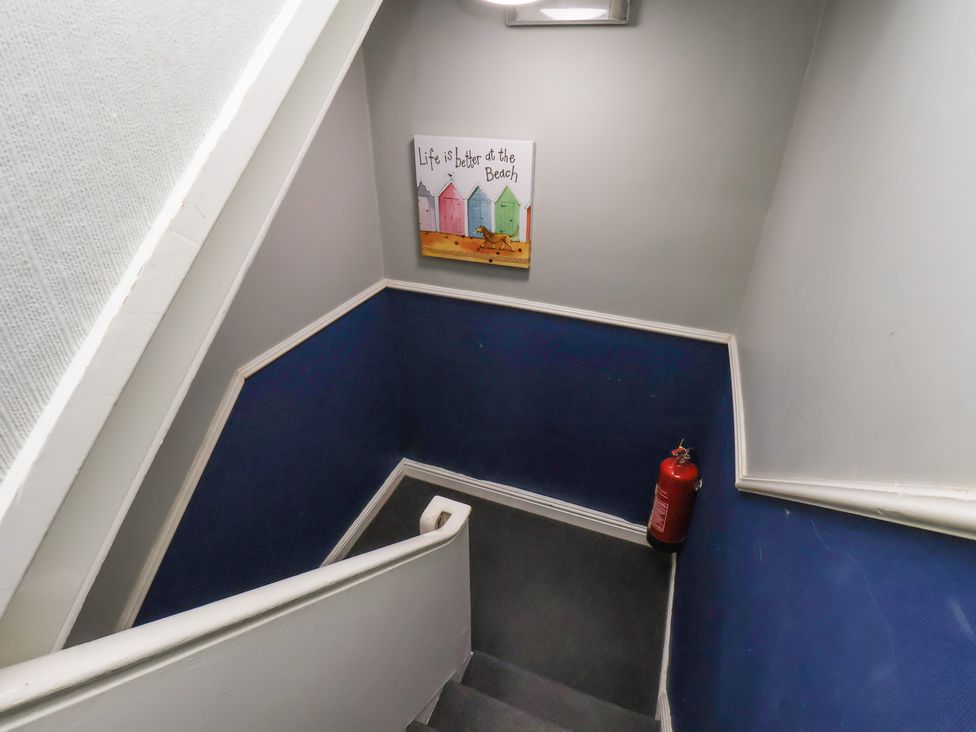 A staircase with wall artwork and a fire extinguisher at Apartment 3 in Scarborough