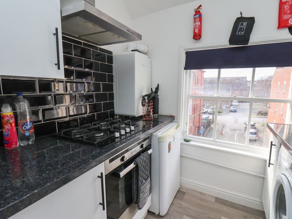 A kitchen with stove, fridge and window at Apartment 3 Scarborough