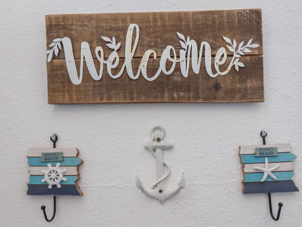 A welcome sign with beach-themed decor at Apartment 3 Scarborough