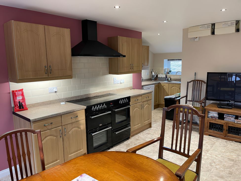 A kitchen with cabinets and appliances at 15 New Shawbost in Shawbost