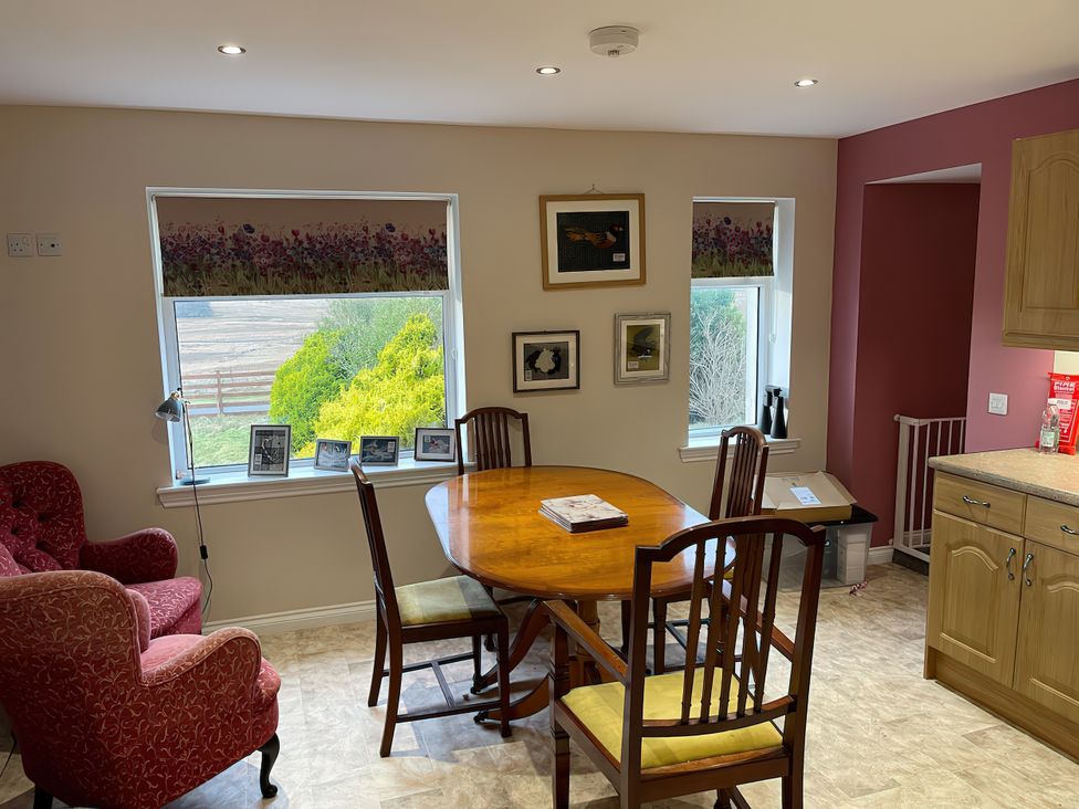 A dining room with a table and chairs at 15 New Shawbost in Shawbost
